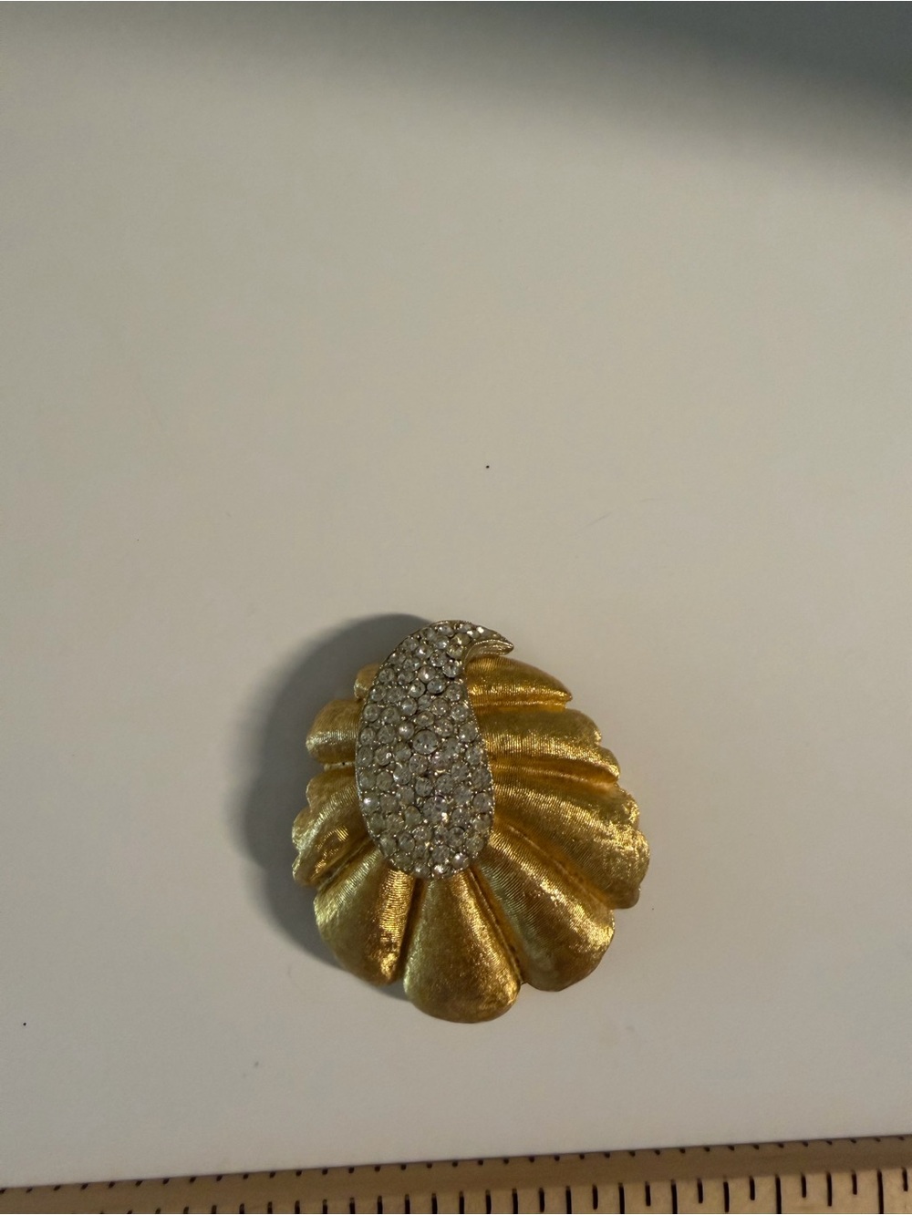 BSK vintage gold tone/rhinestone seashell brooch. Pin back has a bend.